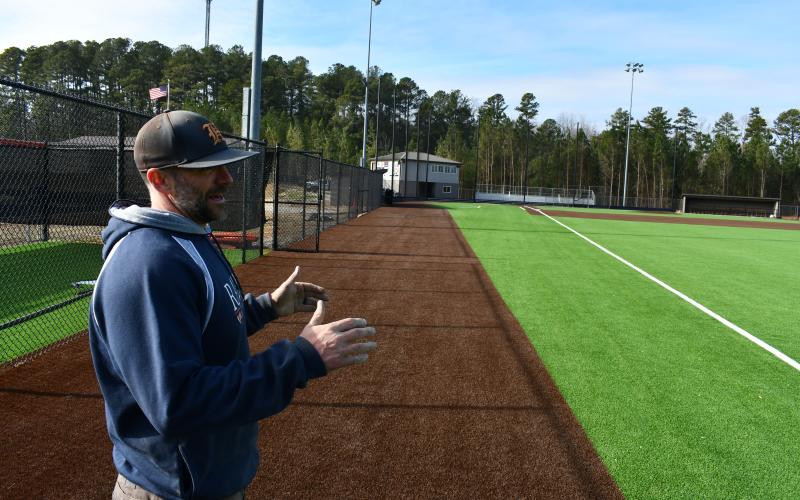 Raiders coach Chris Akridge gives a tour of the new field and explains its many amenities. MATTHEW OSBORNE/Staff