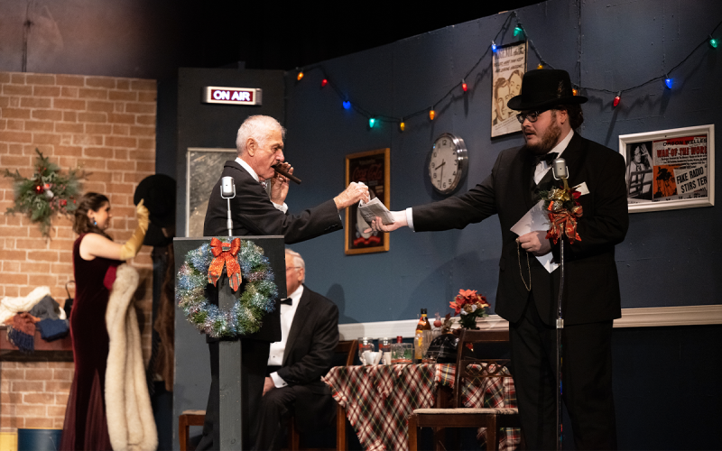 Dylan Truong plays Uncle Billy who is seen handing a newspaper to Jack Molnar who plays stingy old Henry Potter (left). ZACH TAYLOR/Submitted