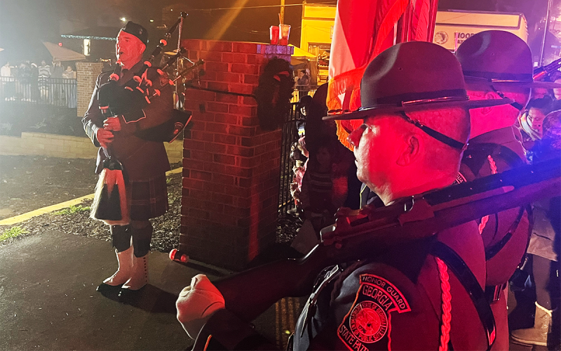 A Georgia State Patrol Honor Guard plays while the family and friends of  Edgar Flores enter the Baldwin city park. MATTHEW OSBORNE/Staff