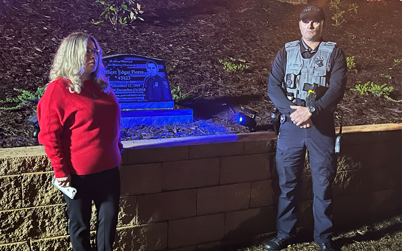 Laura Flores and Baldwin Police Chief Chris Jones unveil a monument to Officer Edgar Flores, who was killed in the line of duty in 2018. MATTHEW OSBORNE/Staff