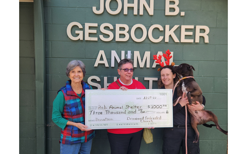 Shown are Church Treasurer Alta Moseley and Pastor Joyce Acree (left) presenting Nix and Bagheera with $3,000 to aid in transportation of dogs. ALTA MOSELY/Submitted