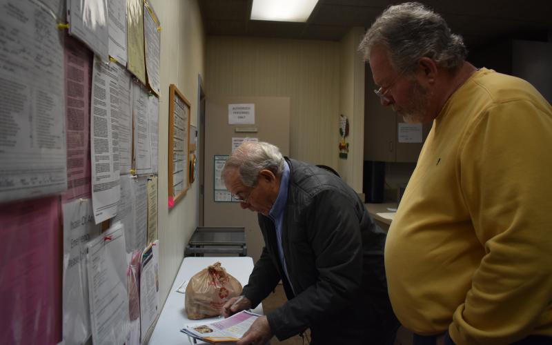 Meals on Wheels volunteers Bill Gaik and Martin May prepare for their route before hitting the road. EMMA MARTI/Staff