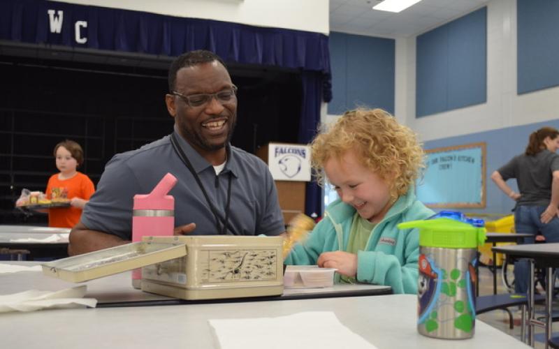 Tesnatee Gap Principal Octavius Mulligan shares a laugh with kindergartner Raleigh Brode in the cafeteria. SAMANTHA SINCLAIR/White County News
