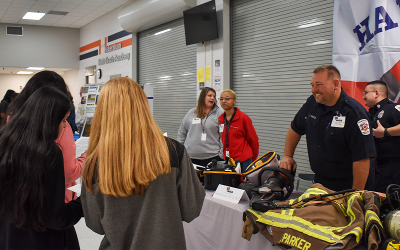 Jeffrey Parker with Habersham Fire &amp; EMS greets students at the beginning of the College and Career Day Wednesday. During the event, students at the Ninth Grade Academy were given BINGO sheets with various questions to ask the organizations and colleges to further their knowledge on the groups. EMMA MARTI/Staff