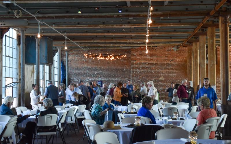 Guests mingle during the social hour at the Soque River Watershed Association Soirée on Saturday evening, talking with  longtime friends, enjoying a drink or looking at the items being raffled off. EMMA MARTI/Staff