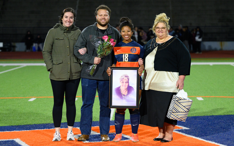 Trinity Moon (second from right) and her family pose with a photo of her late grandmother during the senior night ceremony at Raider Stadium. ZACH TAYLOR/Special