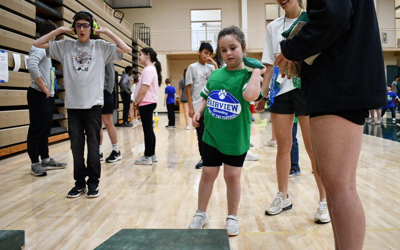 Abigail Cantrell takes aim during a game of cornhole at the PAL Games on Friday. JOHN DILLS/Staff