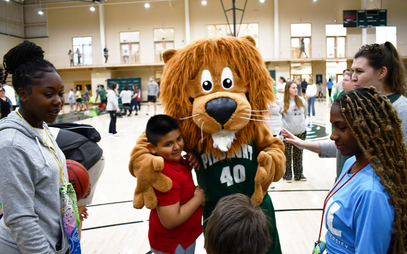 Jose Juarez takes a moment from his fun Friday morning to hug Leo The Lion. JOHN DILLS/Staff