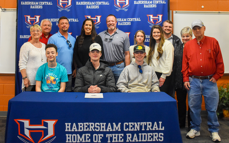 Joining Braydon Wright at his signing ceremony Wednesday are (seated, from left) brother Jaxson Wright, Braydon and brother Landon Wright. Standing are (from left) grandmother Deborah Wright, grandfather Steve Wright, father Andy, mother Michelle, George Alexander, sister Mia Wright, sister Katelyn Wade, Wade’s fiance Trevor Burton, Vicki Harron and Weldon Harron. EMMA MARTI/Staff