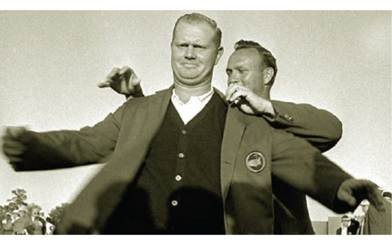 This 1963 Associated Press photo shows Arnold Palmer helping Jack Nicklaus slip into his first of six Masters green jackets. As high school freshmen, Pete Hires and I joined Arnie’s Army to march in the golf gallery at the Augusta National Golf Club. On that Sunday, we watched Palmer, the 1962 winner, award the young Golden Bear his first green jacket – golf’s Holy Grail.