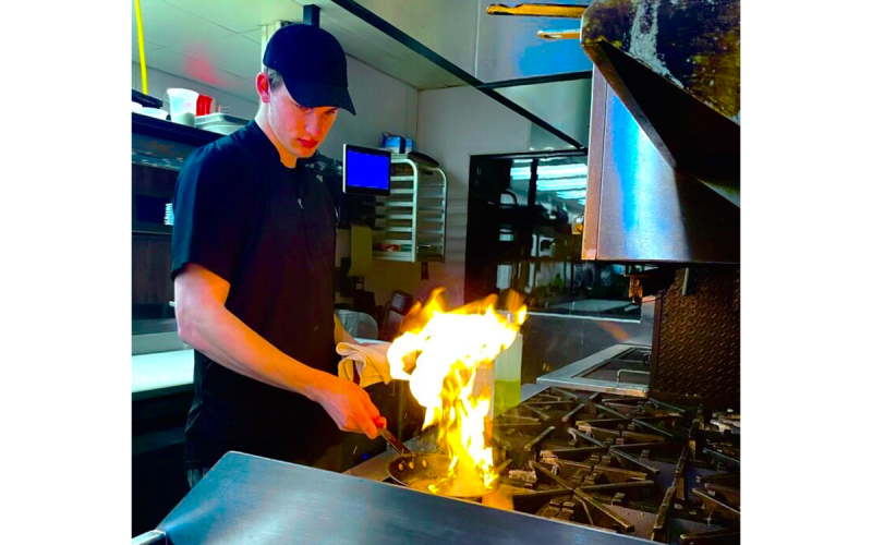 Jace Reeder gets his dish going during one of his shifts at Community Brew &amp; Tap in Cornelia. Reeder also cooks at Fenders Diner. SUBMITTED
