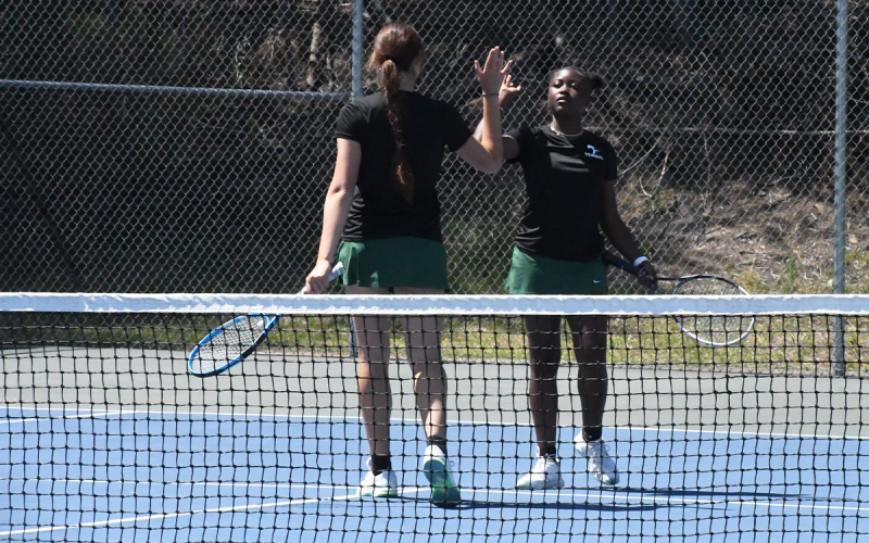 Tallulah Falls’ Katarina Foskey (left) and Azaria Junaid celebrate a point during their No. 1 doubles match on Monday. LANG STOREY/Staff