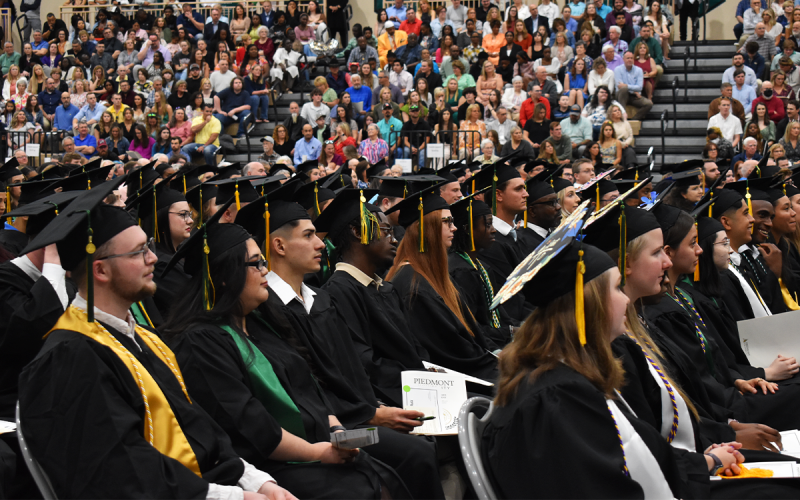 Students patiently wait for their turn to cross the stage and receive their hard-earned diplomas. EMMA MARTI/Staff