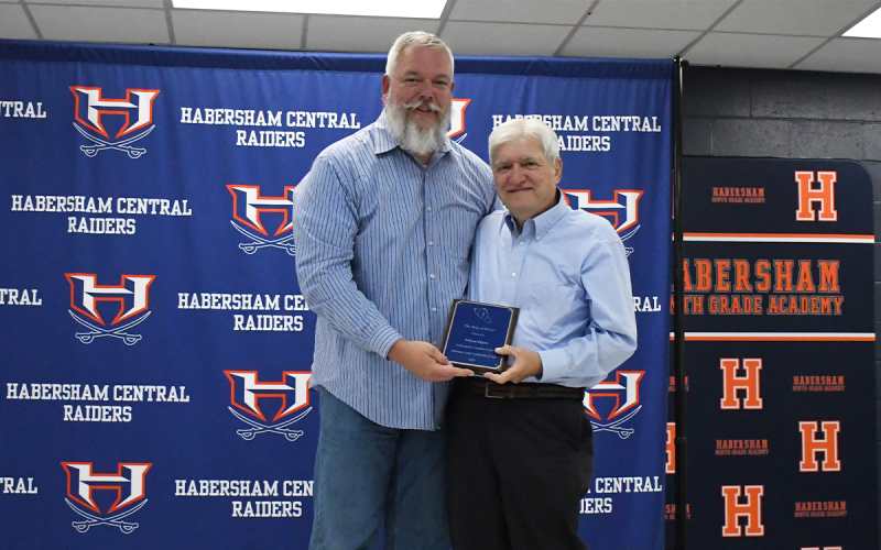 Sheriff Joey Terrell (left) presented former Band of Blue Director  Nelson Payne. LANG STOREY/Staff