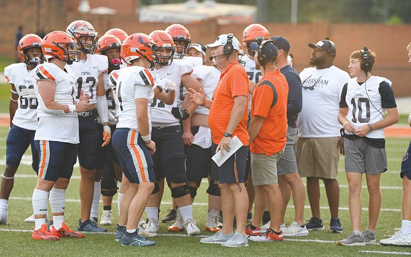 Raiders coach Benji Harrison chats with players during a time out. TOM ASKEW/Special