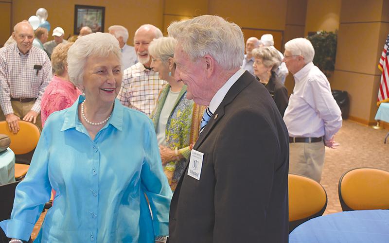 Larry Whitfield is greeted by Linda Rice during his birthday party.