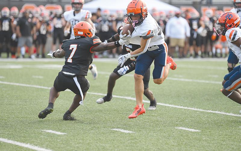 Not even grabbing the jersey of Habersham Central’s Zeke Whittington can slow him down. Whittington broke away here and still outran more defenders during Friday night’s spring game in Hartwell. TOM ASKEW/Special