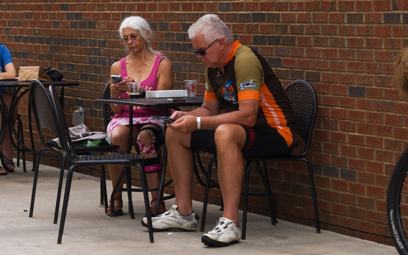 Bill Littmann (right) rests his feet after pedaling over 30 miles through Habersham County. MATTHEW OSBORNE and ZACH TAYLOR/Staff