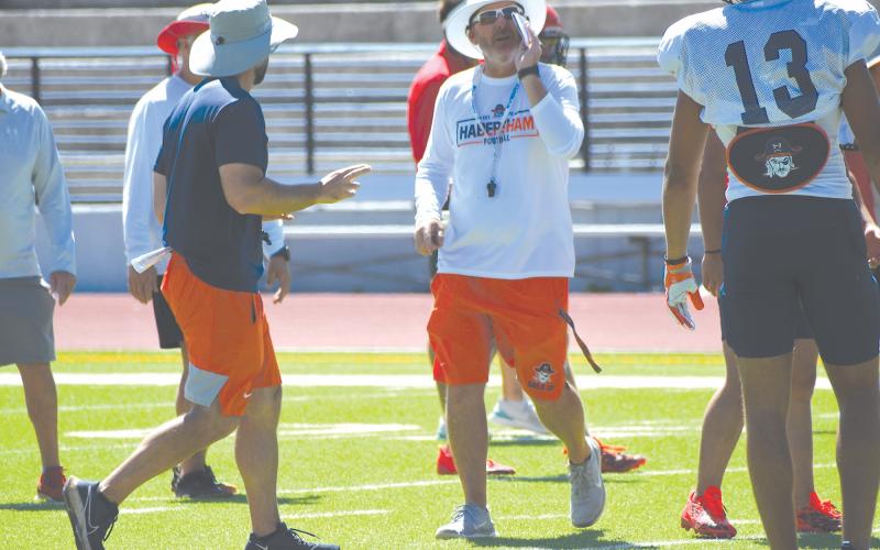 Raiders head coach Benji Harrison shouts instructions to players during padded camp. LANG STOREY/Staff
