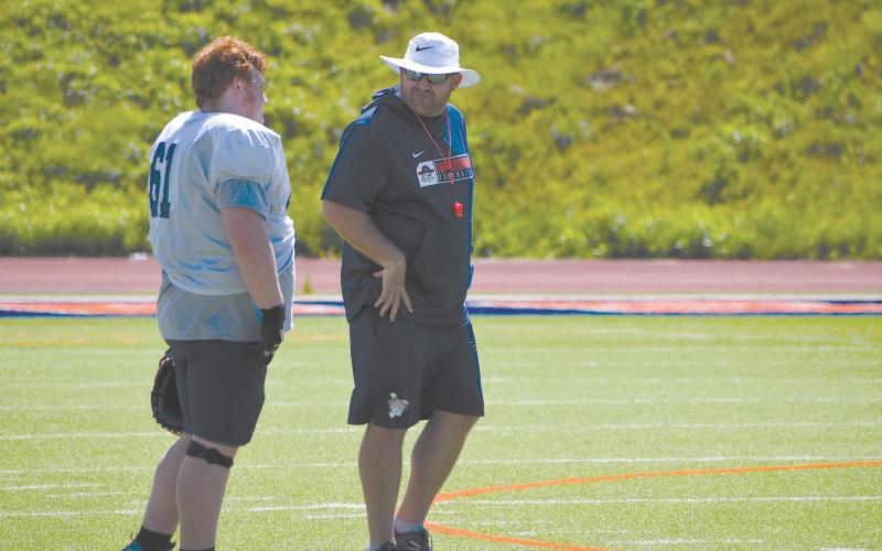 Raiders assistant head coach Cody Honeycutt takes a minute to chat with Leland Sheets during a time out Monday morning. LANG STOREY/Staff