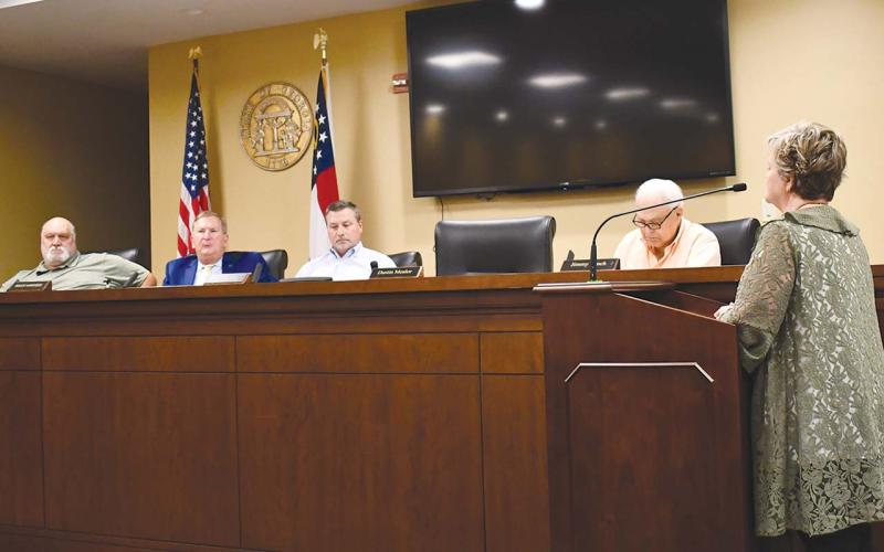 Lisa Nicholson (right) expresses to the county commission how the grinding and mulching operation could cause additional traffic issues within the area. JOHN DILLS/Staff