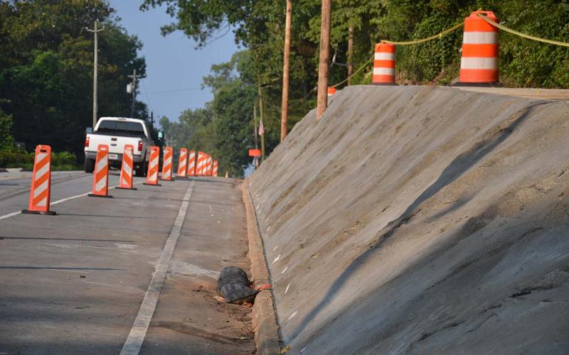 Demorest has its new wall almost finished, but the sidewalk above will still be closed during the holiday and beyond while the city waits for materials for the safety handrail. MATTHEW OSBORNE/Staff