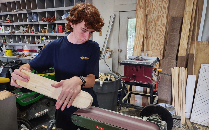 Matthew Wolfe cuts a piece of wood for his Eagle Scout project. SUBMITTED
