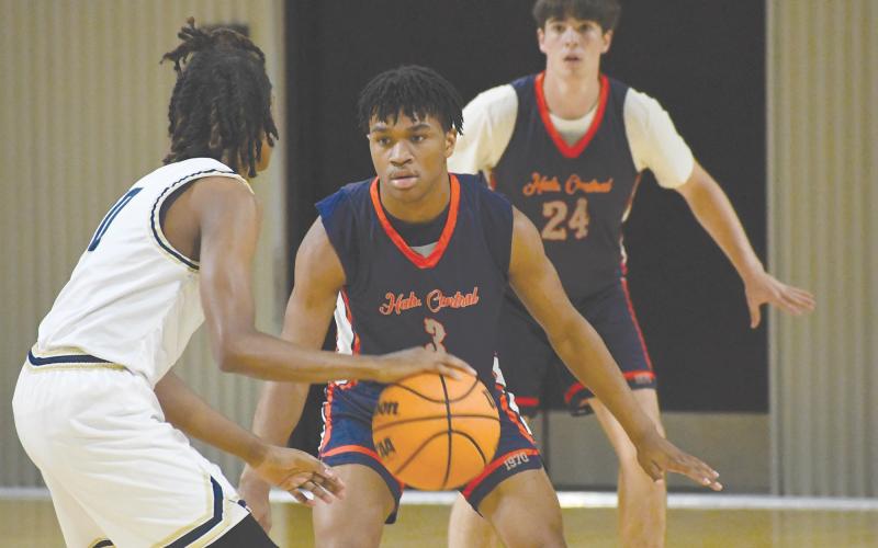 Justus Gober (3) and Jayden Arria lock in on defense. LANG STOREY/Staff