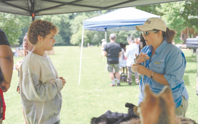 Kyra Purdee (left) speaks with Georgia DNR Interpretive Ranger Kathy Church about the Eastern Garter Snake, among other snakes, which were brought out for the Soque River Festival on June 24. ZACH TAYLOR/Special