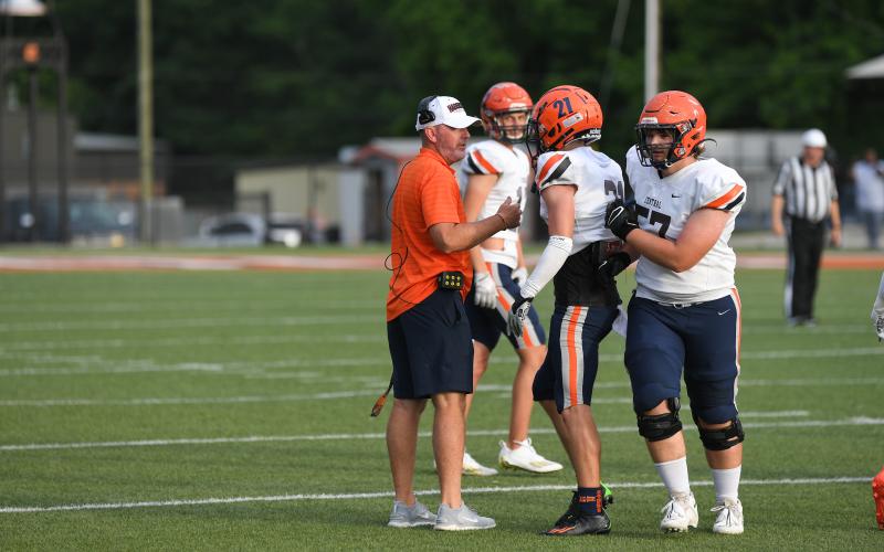 Raiders coach Benji Harison consults with players during the spring game against Hart County. TOM ASKEW/Special