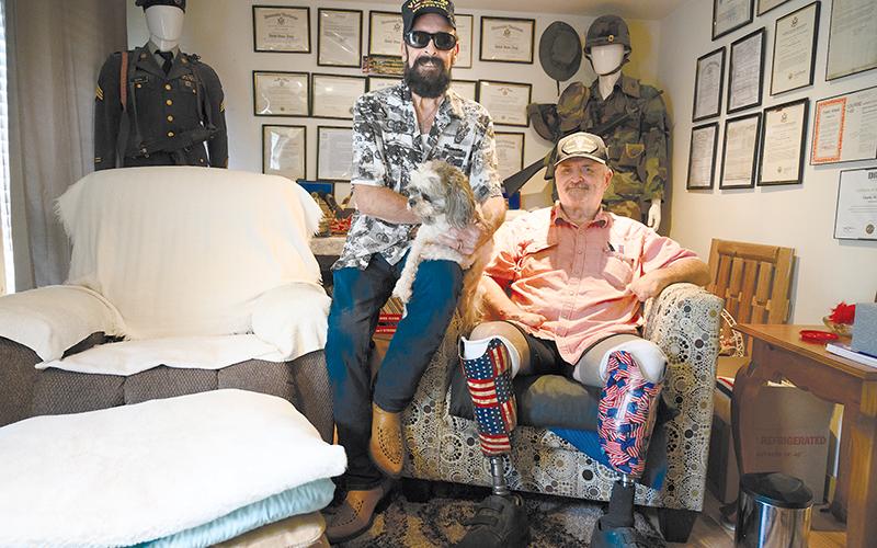 Vietnam veterans Charlie Mack Booth and Ray Bowen sit in the den at Charlie’s house, which features a plethora of military memorabilia dating back to World War II. ZACH TAYLOR/Special