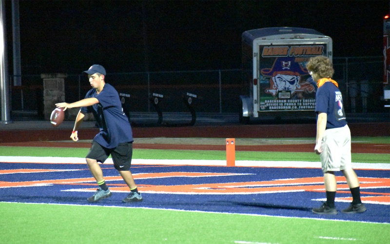 Band of Blue members Connor Brookshire and Blake Howard squared off in a punt-pass-kick. MATTHEW OSBORNE/Staff