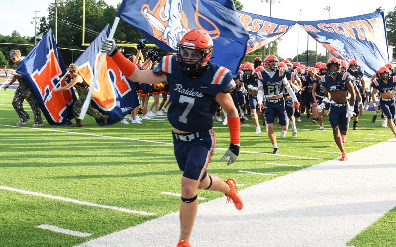 Braden Henslee leads the fellas out for the preseason game. TOM ASKEW/Special