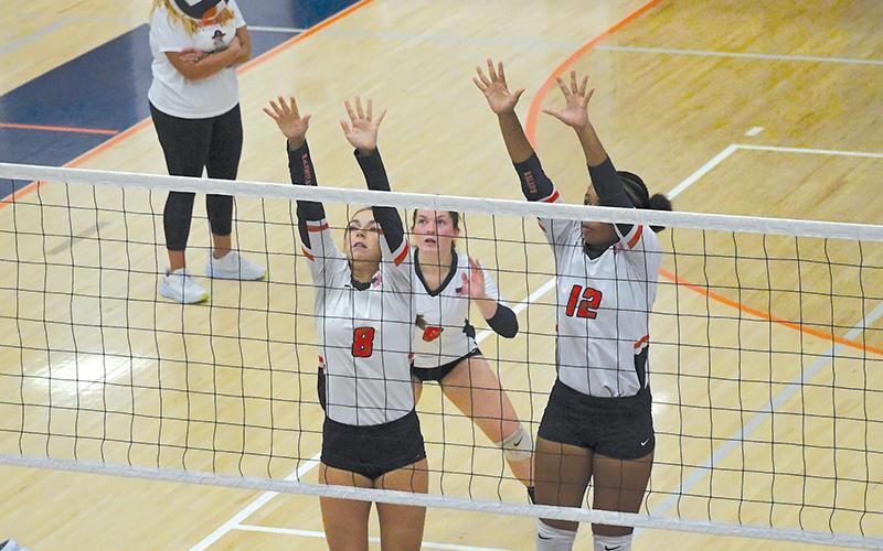 Habersham Central's Laci Fitzgerald, Brooke Blackburn and Da'Riyah Bell look to block at the net against Seckinger. LANG STOREY/Staff
