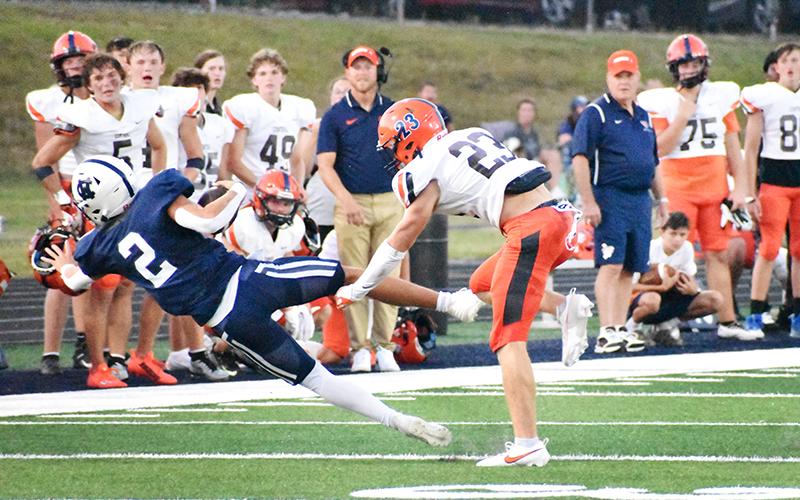 Habersham Central’s Carter  Barrett (23) knocks White County  quarterback Tripp Nix (2) off his  feet during Friday night’s game. MATTHEW OSBORNE/Staff