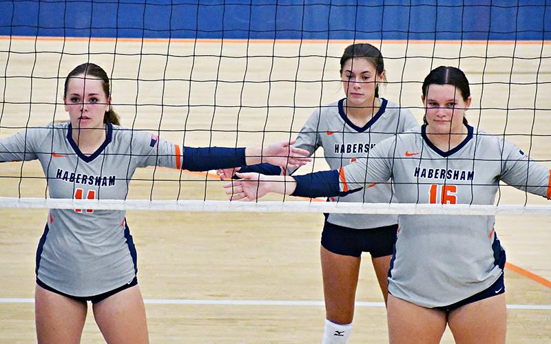Habersham Central’s Jayden Jarrett (11), Ava Saxon and Callyn Chosewood (16) await a serve during a recent home match.