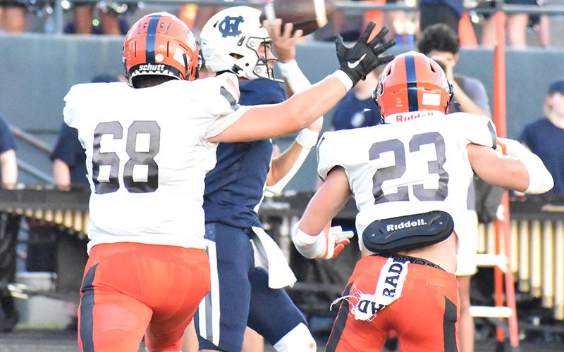 Habersham Central defenders Aidan Cianci (68) and Carter Barrett (23) chase White County quarterback Tripp Nix during the Aug. 25 game.