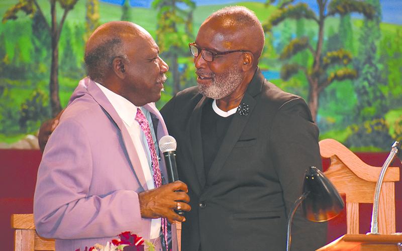 Bishop Ernest Burns (right) of Shady Grove Baptist Church in Cornelia confers with Elder Leon Bradshaw during a service Sunday to celebrate Burns’ 25th year as pastor. MATTHEW OSBORNE/Staff