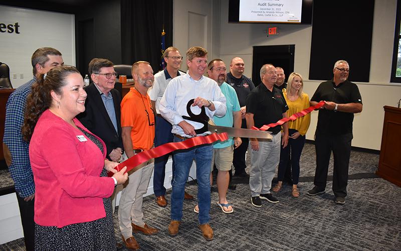 Demorest Mayor Jerry Harkness cuts the ribbon Tuesday at the new Demorest Municipal Conference Center inside the city hall building. Shown are (from left) Chamber of Commerce President Ellie Van Doonum, Councilmen Shawn Allen, Dr. John Hendrix and Donnie Bennett, Chamber Board President Clayton Foster, Councilman Andrew Ferguson, Fire Chief Jonathan Kinght, Assistant Police Chief Casey Chastain, City Manager Mark Musselwhite, City Clerk Megan Chastain and Howard Bell from ACG. MATTHEW OSBORNE/Staff