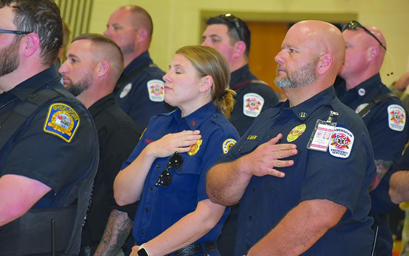 Habersham County Sheriff’s Investigator George Cason, Gwinnett County EMS Ashley Fields and Habersham County EMS Matt Ruark pledge to the flag. MATTHEW OSBORNE/Staff