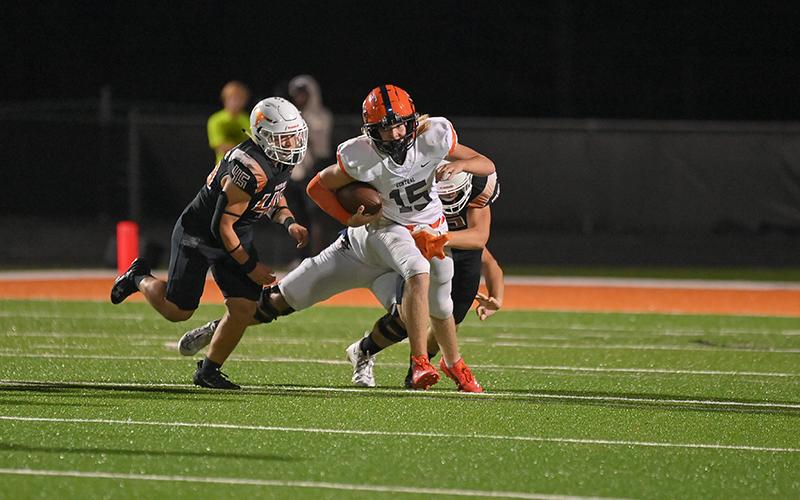 DJ Pass looks to escape tacklers during his relief stint. TOM ASKEW/Special