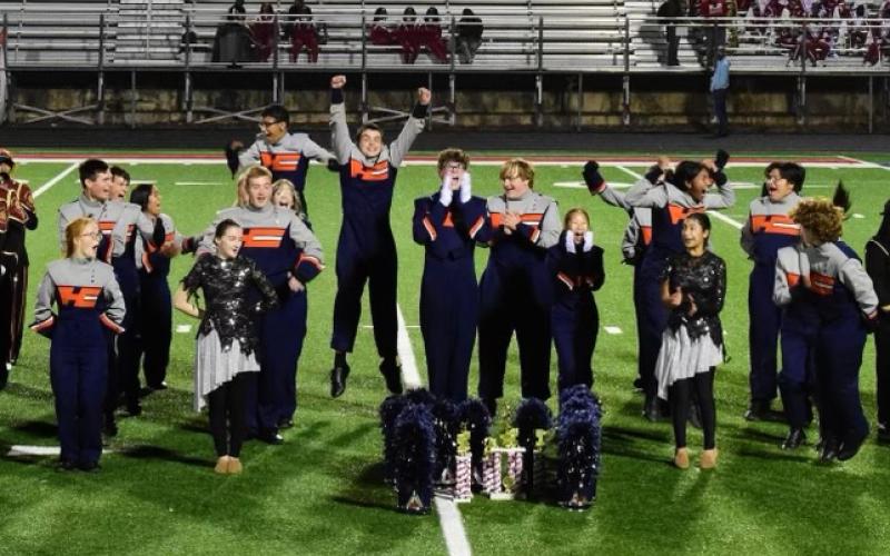 The Band of Blue celebrates their achievement. Submitted
