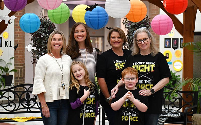 Phoebe Groves (left) and Monroe Bogue (right) pose with faculty and staff at Fairview Elementary School. In back are Principal Michelle Wilbanks, Assistant Principal Jennifer Adams, Vision Paraprofessional Sherry Crain, and Vision Teacher Robin Skelton. JULIANNE AKERS/Staff