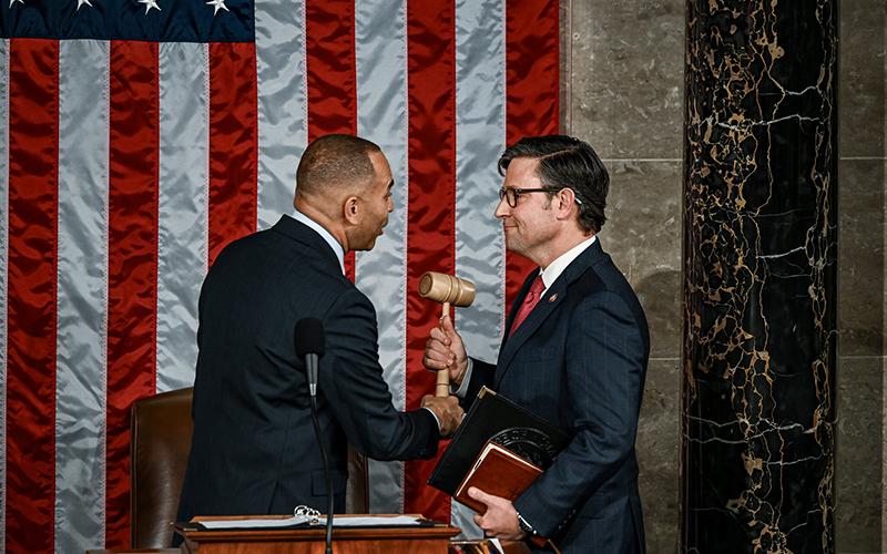 Speaker Mike Johnson is handed the gavel on Wednesday. THE NEW YORK TIMES