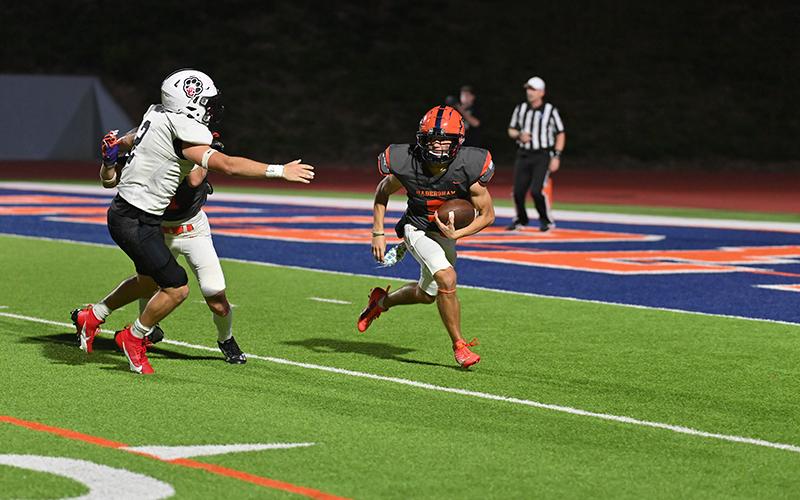Zeke Whittington runs during a brief stint at quarterback Friday night. TOM ASKEW/Special