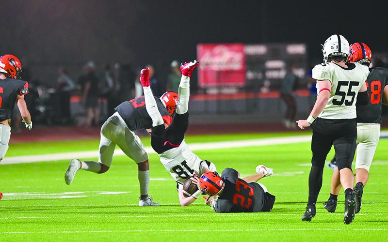 Habersham Central’s Carter Barrett (23) and Keller Green upend Jackson County’s Slade  Swierczek during their last home game. TOM ASKEW/Special