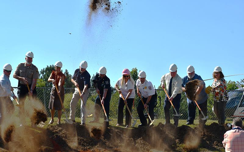 Members of the Habersham County government and first responders and emergency service workers break ground at Ruby Fulbright Aquatic Center, the symbolic site of the new public safety radio system in the county. From left are Sheriff Joey Terrell, County Manager Alicia Vaughn, Public Works Director Jerry Baggett, Shawn Benfield, 911 Director Lynn Smith, Emergency Medical Services Director Jeff Adams,  Bruce Harkness, Bruce Palmer and Stephanie Walker. JULIANNE AKERS/Staff