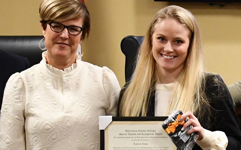 Lauren Long (right), shown being honored by County Manager Alicia Vaughn last year, has been writing grants for the county for 15 months. FILE