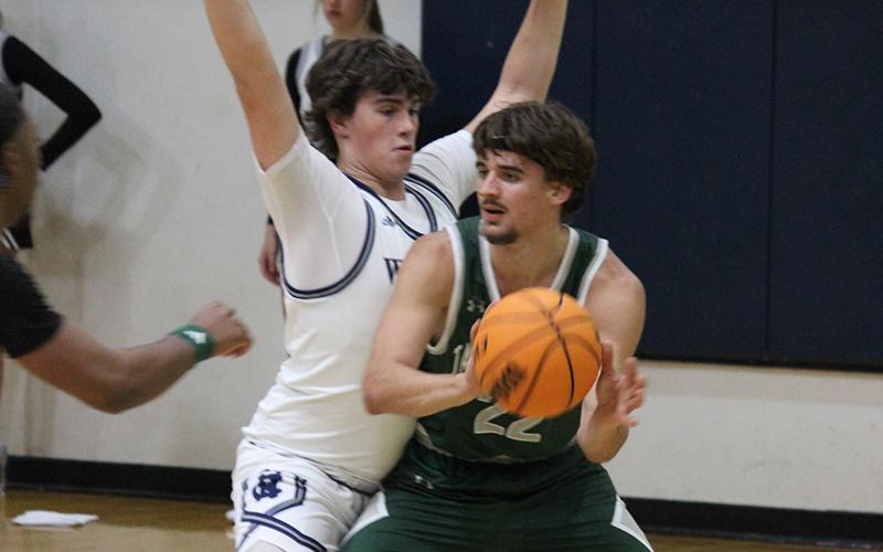 Zakhar Valasiuk looks to pass out of the post during the Indians’ win over White County on Tuesday night. ELI SHOEMAKE/CNI News Service