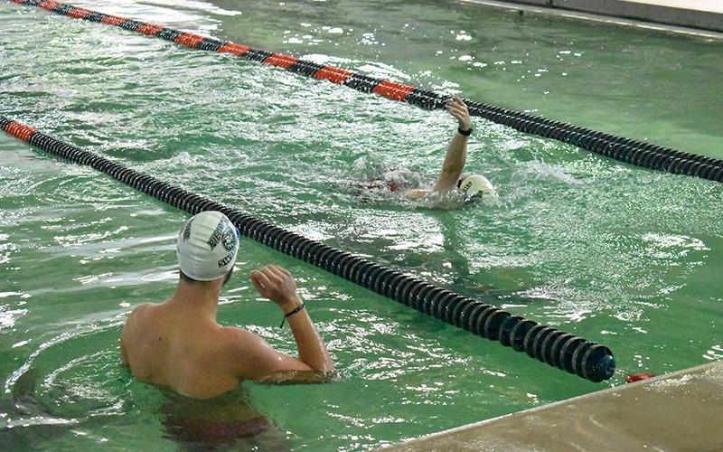 Piedmont swimmer Sam Teed looks on as teammate Will Donaldson swims laps on Monday. The pool was closed for almost two months and the repairs spilled into swim season, canceling the first home meet. Piedmont, Habersham Central and youth swimmers all use the facility for practice as well. LANG STOREY/Staff
